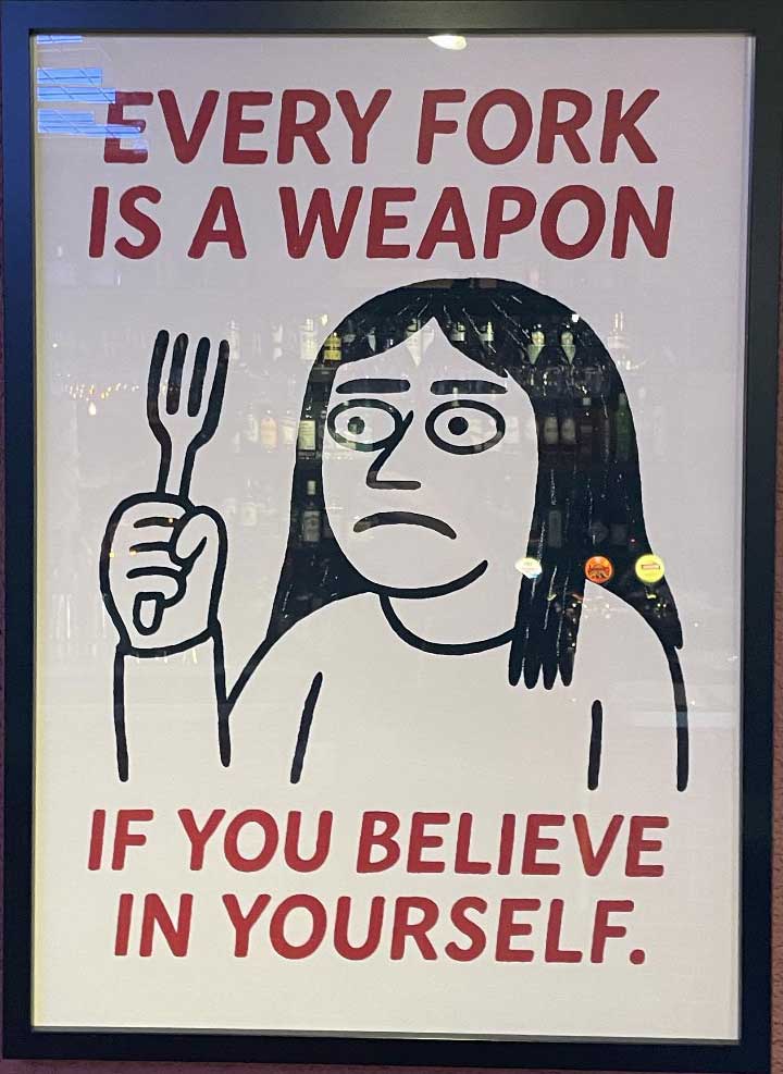 Inramad skylt med texten Every fork is a weapon